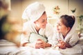 Portrait of Mother and daughter in bed, Looking etch other.