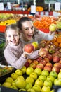Mother and daughter buying apples . Royalty Free Stock Photo