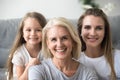 Portrait of mother, daughter and grandmother making family pictu