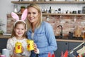 Portrait of smiling mother and daughter with handmade Easter chickens Royalty Free Stock Photo