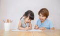 Portrait of mother and daughter learning to write. Royalty Free Stock Photo