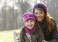 Portrait mother and daughter outdoors in winter