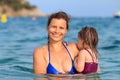 Portrait of mother and daughter swimming in the sea. Summer vacation on the sea beach. Happy family swims in the sea Royalty Free Stock Photo