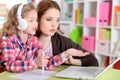 Portrait of mother and daughter using laptop at home Royalty Free Stock Photo