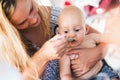 Portrait of mother feeding her baby with spoon Royalty Free Stock Photo