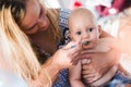 Portrait of mother feeding her baby with spoon Royalty Free Stock Photo