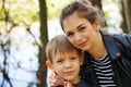 Portrait of mother and her little son on walk in countryside. Close up of young woman with child in nature. Royalty Free Stock Photo