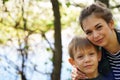 Portrait of mother and her little son on walk in countryside. Close up of young woman with child in nature. Royalty Free Stock Photo