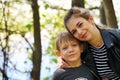 Portrait of mother and her little son on walk in countryside. Close up of young woman with child in nature. Royalty Free Stock Photo