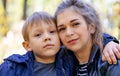 Portrait of mother and her little son on walk in countryside. Close up of young woman with child in nature. Royalty Free Stock Photo