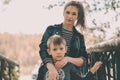 Portrait of mother and her little son on walk in countryside. Close up of young woman with child in nature. Royalty Free Stock Photo