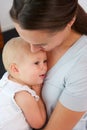 Portrait of mother holding baby close to her chest Royalty Free Stock Photo