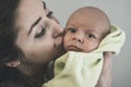 Portrait of mother holding and kissing her baby Royalty Free Stock Photo