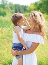 Portrait of mother hugging child son outdoors in summer Royalty Free Stock Photo