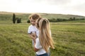 Portrait of a mother hugs her cute son, they look at each other and smile outside Royalty Free Stock Photo