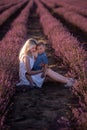 Portrait mother with little son are sitting in purple lavender field. Concept of allergy, travel