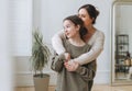 Portrait of mother middle age woman and daughter teenager together in thelight interior