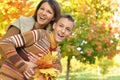 Portrait of a mother with son hugging outoors in autumnal park