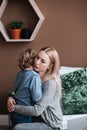 Portrait of mother and son hugging smiling intdoors. Positive relations. Mum and son together. Royalty Free Stock Photo