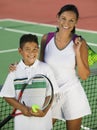 Portrait Of Mother And Son By Net On Tennis Court Royalty Free Stock Photo