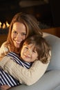 Portrait mother and son sitting in front of fire Royalty Free Stock Photo