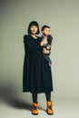 Portrait of mother and son standing in studio