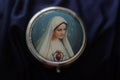 Portrait of Mother Virgin Mary on a cover of round metal rosary box. Pray rosary devotion concept. Catholic religion symbol. Royalty Free Stock Photo