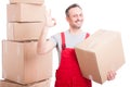 Portrait of mover guy holding box showing okay gesture