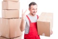 Portrait of mover guy holding box showing two gesture