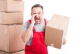 Portrait of mover man holding box and screaming loud