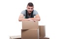 Portrait mover man posing behind cardboard boxes