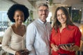 Portrait Of Multi-Cultural Business Team With Digital Tablet In Busy Office Royalty Free Stock Photo