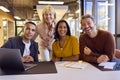 Portrait Of Multi-Cultural Business Team Meeting Around Laptop In Modern Office Royalty Free Stock Photo