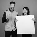 Portrait of multi ethnic diverse couple in studio showing copy space Royalty Free Stock Photo