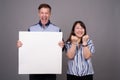 Portrait of multi ethnic diverse couple in studio showing copy space Royalty Free Stock Photo