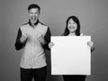 Portrait of multi ethnic diverse couple in studio showing copy space Royalty Free Stock Photo