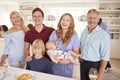 Portrait Of Multi-Generation Family And Friends Gathering In Kitchen For Celebration Party Royalty Free Stock Photo