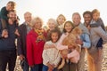 Portrait Of Multi-Generation Family Group With Dog On Winter Beach Vacation Royalty Free Stock Photo