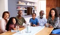 Portrait Of Multi-Generation Family Sitting Around Table At Home Enjoying Meal Together Royalty Free Stock Photo