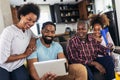 Multi generation family sitting in living room and using tablet pc Royalty Free Stock Photo