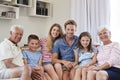 Portrait Of Multi Generation Family Sitting On Sofa At Home Royalty Free Stock Photo