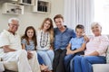 Portrait Of Multi Generation Family Sitting On Sofa At Home Royalty Free Stock Photo