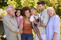 Portrait Of Multi-Generation Family Standing In Garden Smiling At Camera Royalty Free Stock Photo