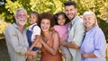 Portrait Of Multi-Generation Family Standing In Garden Smiling At Camera Royalty Free Stock Photo