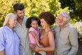 Portrait Of Multi-Generation Family Standing In Garden Smiling At Camera Royalty Free Stock Photo