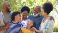 Portrait Of Multi-Generation Family Standing Outdoors In Garden Or Countryside Smiling At Camera Royalty Free Stock Photo