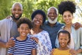 Portrait Of Multi-Generation Family Standing Outdoors In Garden Or Countryside Smiling At Camera Royalty Free Stock Photo