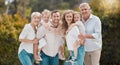 Portrait of multi-generation family standing together. Extended caucasian family smiling while spending time together at Royalty Free Stock Photo