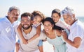 Portrait of multi generation family on vacation at the beach together. Mixed race family with two children, two parents Royalty Free Stock Photo