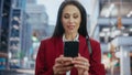 Portrait of Multiethnic Adult Businesswoman Using Smartphone on Street in a Big City. Confident